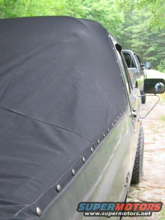 84-softtop-(4).jpg Custom made boat canvas Fastback style soft top, no rear window. Snaps attached to body. Passenger side view.