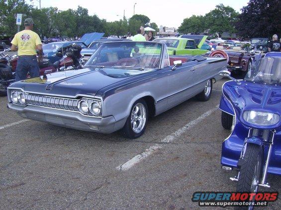Silver and dark blue convertible with chrome grille and wheels