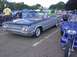1970 Ford Ranchero - A two-tone convertible with a distinctive chrome grille is parked at an outdoor event.