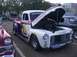 1970 Ford Ranchero - Customized pickup truck with racing livery and open hood at an outdoor event.