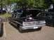 1970 Ford Ranchero - This black sedan, likely a 1964 model, is displayed with its hood open, its engine compartment.