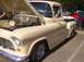 1970 Ford Ranchero - A beige 1955 Chevrolet pickup truck is displayed with its hood open, showing the engine and custom wheels.
