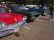 1970 Ford Ranchero - A green 1970 Ford Ranchero is parked next to other classic vehicles at an outdoor car show.
