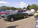 1970 Ford Ranchero - A green 1970 Ford Ranchero is parked at a car show with other vehicles around it.
