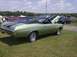 1970 Ford Ranchero - A light green 1970 Chevrolet Chevelle SS is displayed with its hood open at an outdoor car show.