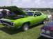 1970 Ford Ranchero - A lime green 1971 Plymouth GTX 440-6 is displayed with its hood open at a car show.