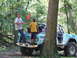 1967 Ford Bronco - A light blue 1967 Ford Bronco is parked in a wooded area with people in the back.