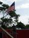 1967 Ford Bronco - American flag flies high above trees and a man on a platform, with the Supermotors logo visible at the bottom.