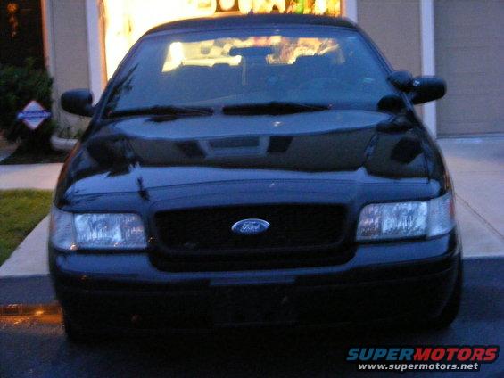 Black 2005 Ford Crown Victoria front view, parked in driveway