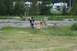 1990 Chevrolet Suburban - Three children are in a field with RVs visible in the distance.