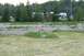 1990 Chevrolet Suburban - A child stands in a grassy area with RVs and other vehicles visible in the distance.