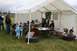 1990 Chevrolet Suburban - An outdoor event with people browsing items under a large tent.