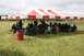 1990 Chevrolet Suburban - People gathered for an event under a large tent in an outdoor setting.