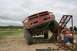 1990 Chevrolet Suburban - A red pickup truck is positioned on a metal ramp during an off-road event.