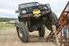 1990 Chevrolet Suburban - A modified off-road vehicle navigates a challenging course with large tires and a winch.