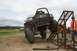1990 Chevrolet Suburban - A modified off-road vehicle navigates a challenging obstacle during an event.