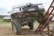 1990 Chevrolet Suburban - A modified Jeep Grand Cherokee is positioned on a metal ramp during an off-road event.