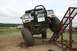 1990 Chevrolet Suburban - An off-road SUV is positioned on a metal ramp, with other vehicles in the background.