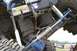 1990 Chevrolet Suburban - Close-up of a heavily modified off-road vehicle's rear suspension system, showing custom air shocks and steering components.