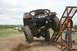 1990 Chevrolet Suburban - A modified Jeep CJ-7 navigates an obstacle course during an off-road event.