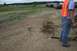 1990 Chevrolet Suburban - Several off-road vehicles are parked in a dirt field, with caution tape marking a boundary.