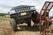 1990 Chevrolet Suburban - Modified black Jeep Grand Cherokee navigates an off-road obstacle course.