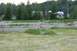 1990 Chevrolet Suburban - A young child plays in a field, with RVs and trees visible in the distance.