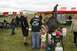 1990 Chevrolet Suburban - An outdoor event features a large barbecue smoker, tents, and people mingling in a grassy area.