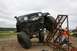 1990 Chevrolet Suburban - A modified Jeep Wrangler attempts to ascend a challenging obstacle during an off-road event.