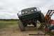 1990 Chevrolet Suburban - A modified Ford F-Series truck navigates an off-road obstacle course during an event.