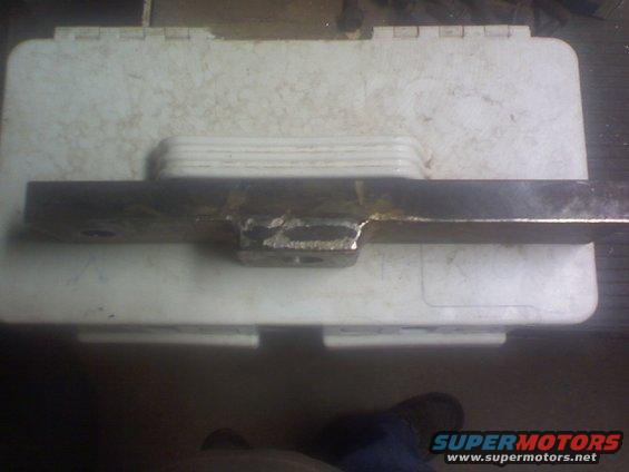 Metal part with welded bracket on a white plastic case