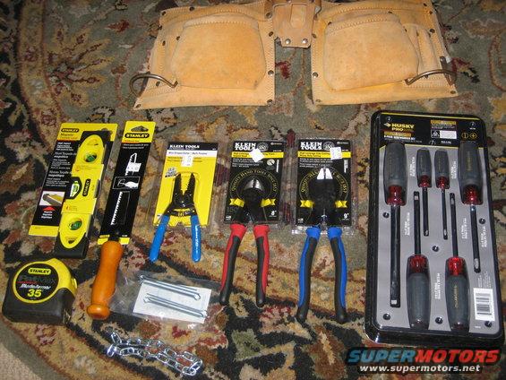 Leather tool belt, tape measure, level, pliers, wire cutters, and screwdriver set