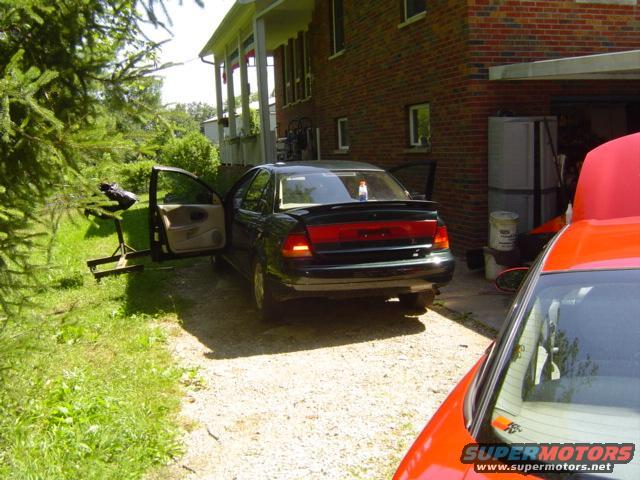 1997 Saturn SC rear view, dark color, doors open
