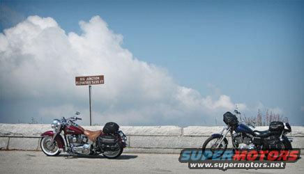 Two motorcycles parked on a scenic overlook with a sign indicating 'BIG JUNCTION ELEVATION 5435 FT'