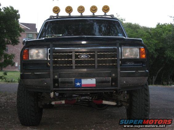 1990 Ford Bronco front view with custom grille guard and smiley face lights on roof rack