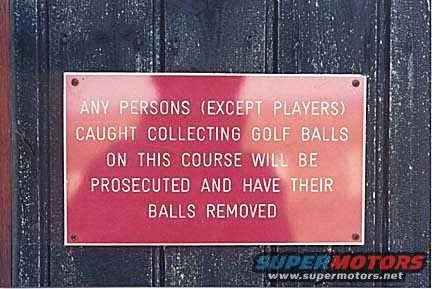 Red sign with white text about collecting golf balls on a wooden background