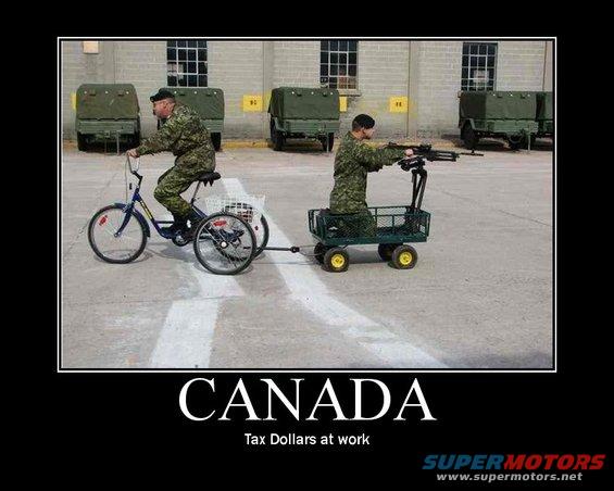 Guy on a tricycle pulls a cart with another guy holding a gun