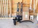 1995 Ford F-150 - Various truck lift kit components are organized on the floor, ready for installation.