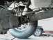 1995 Ford F-150 - Undercarriage view of a 1995 Ford F-150, showing the rear axle and suspension components. Another vehicle is partially visible in the backg…