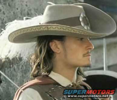Man wearing a wide-brimmed hat with feathers, facing right. Text overlay reads SUPERMOTORS