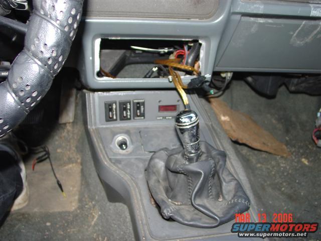 1984 Ford Mustang interior with aftermarket shifter and exposed dashboard wiring