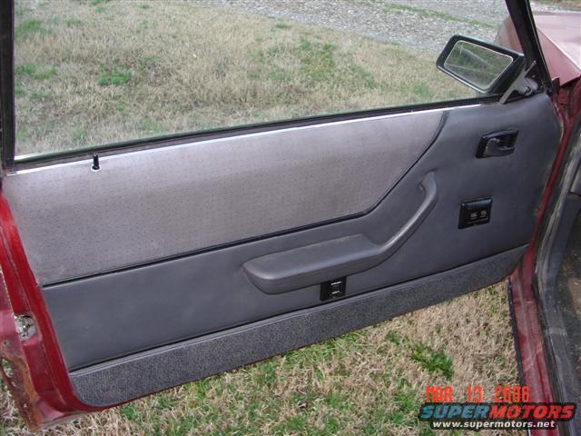 1984 Ford Mustang interior door panel with gray fabric and dark gray plastic trim