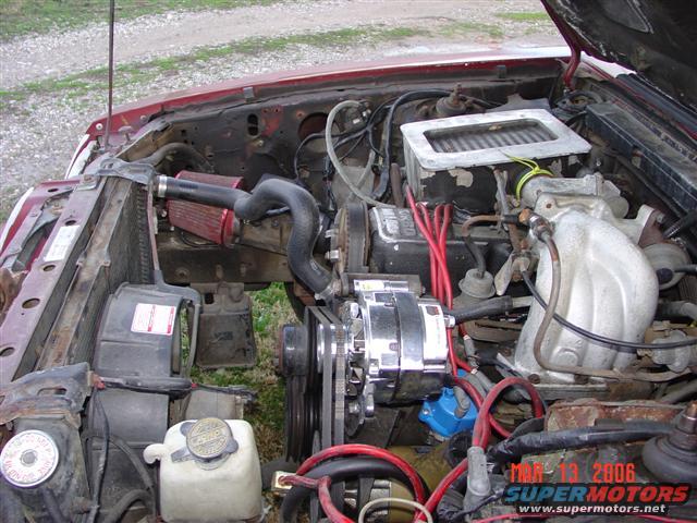 engine bay with aftermarket air intake and chrome alternator