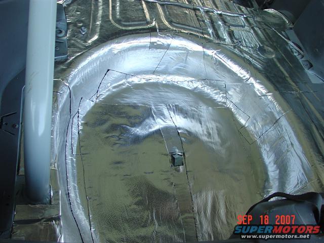 Interior floor covered in sound deadening material, showing cut lines