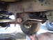 1979 Ford Bronco - Close-up view of the undercarriage of a 1979 Ford Bronco, showing the frame and suspension.