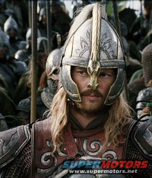 Man in ornate helmet and armor, with blonde hair, looking forward. Text overlay reads 'SUPER MOTORS'