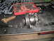 1996 Ford Bronco - Disassembled differential and axle parts are laid out on a workbench next to a set of tools.