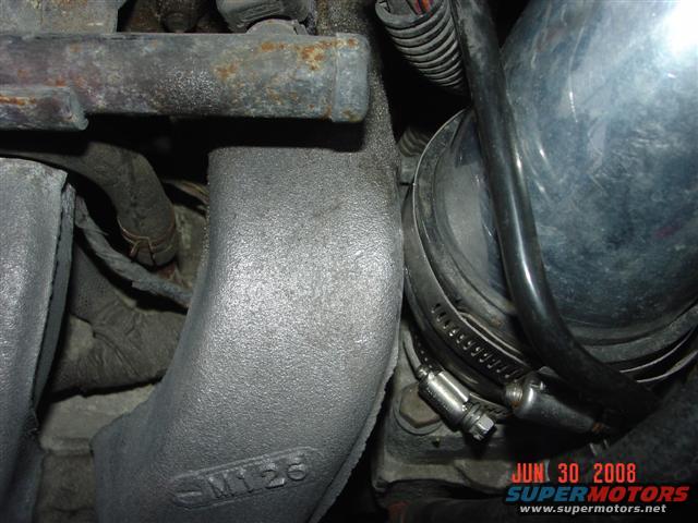 Engine part with M126 marking and hose clamp