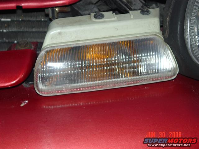 Front side marker light on red car