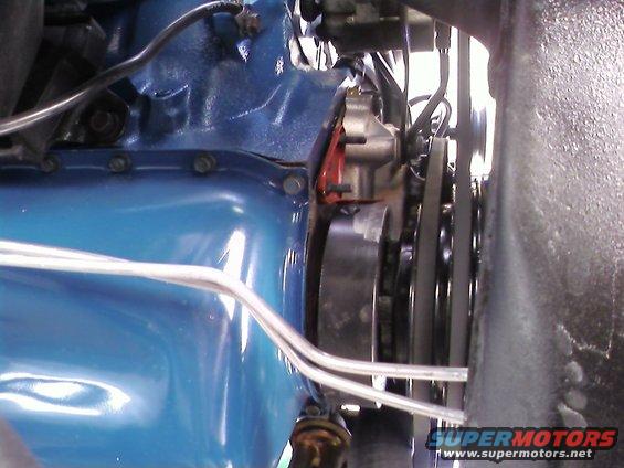 Blue engine block with belts and pulleys
